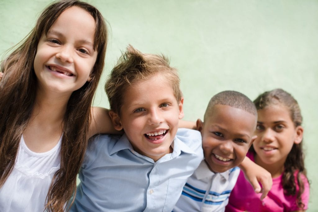 happy children hugging, smiling and having fun