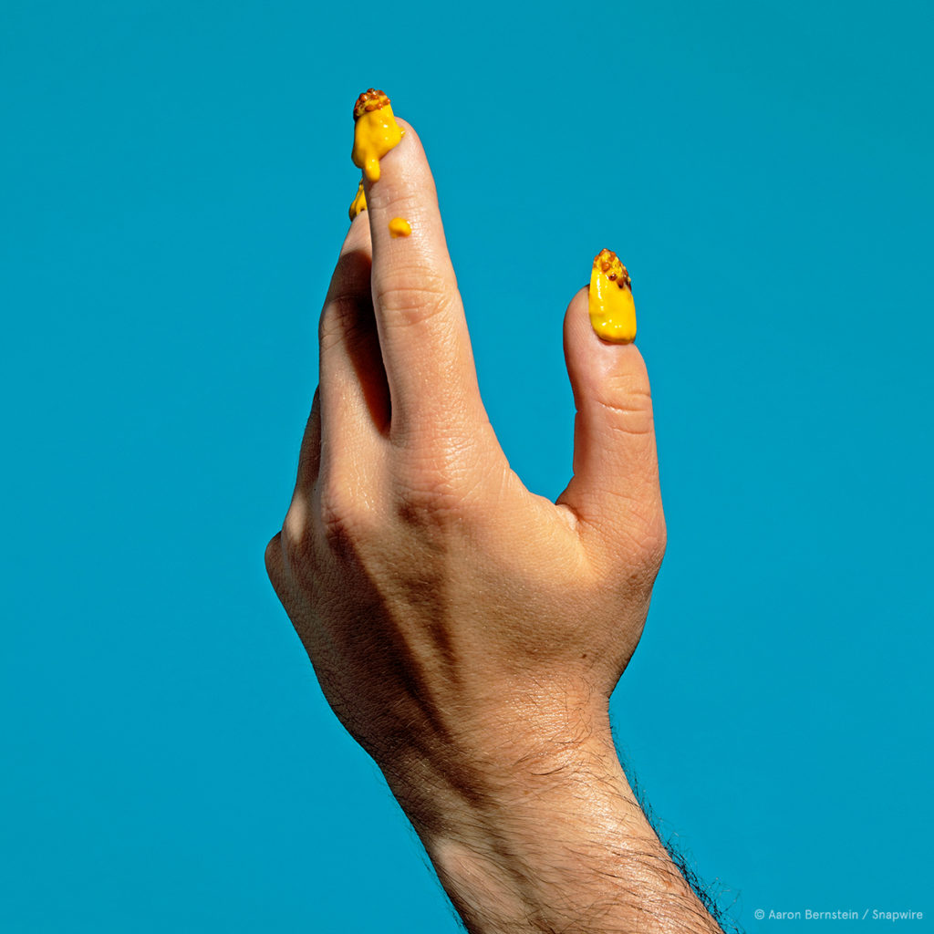 hand portrait with mustard for nails