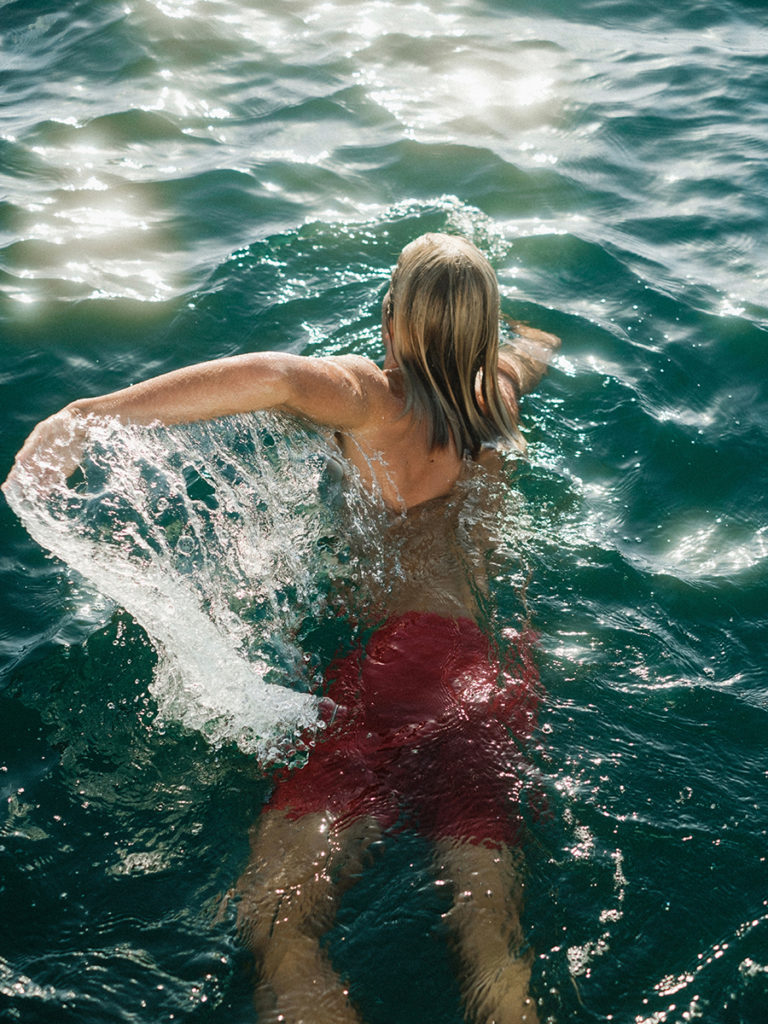 person swimming photo from behind the subject 