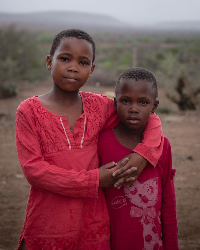 portrait kids with arms around each other