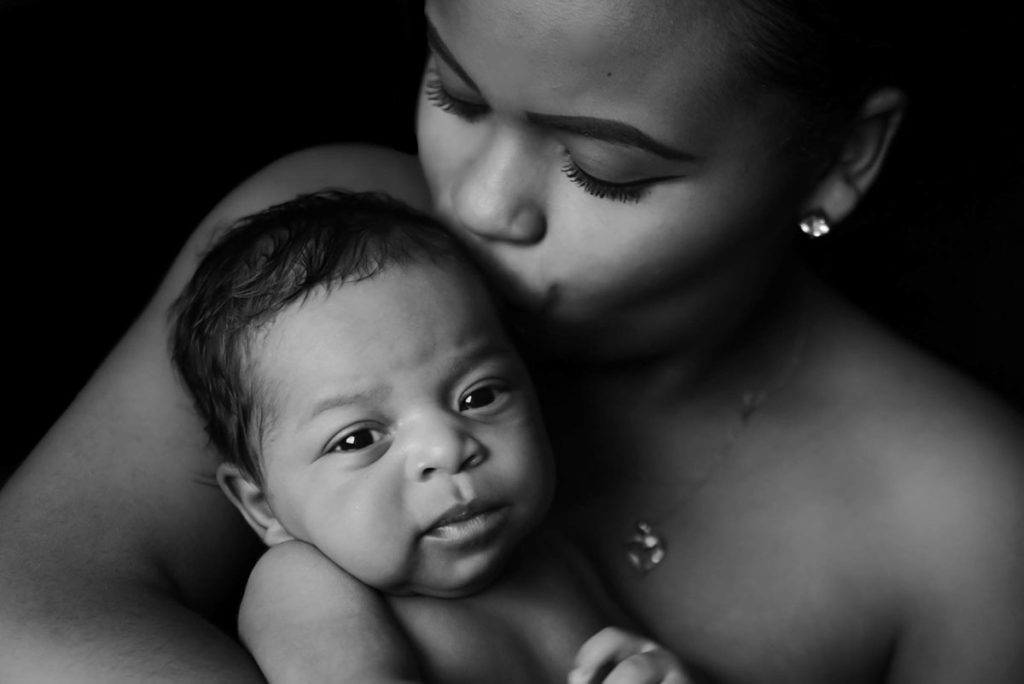 portrait woman kissing a baby