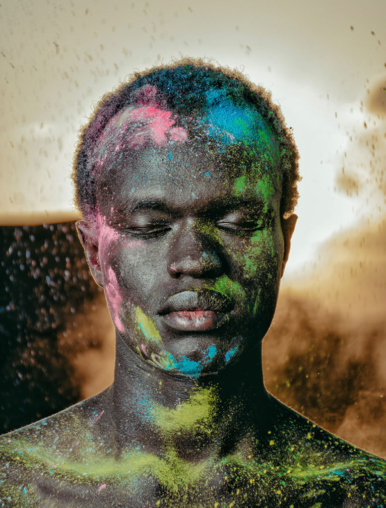 portrait guy covered in colored dust