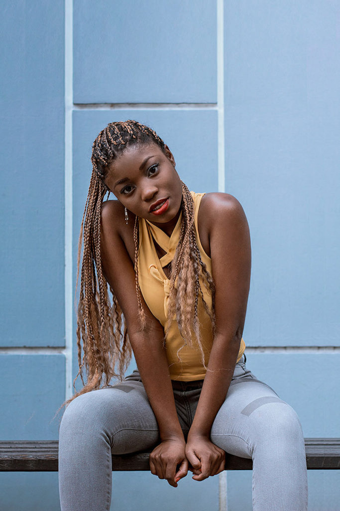 portrait girl in front of a blue wall