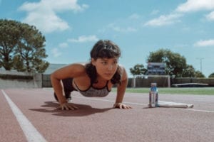 female runner doing pushups