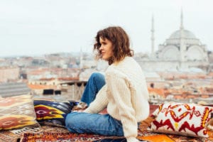 female sitting on colorful rug