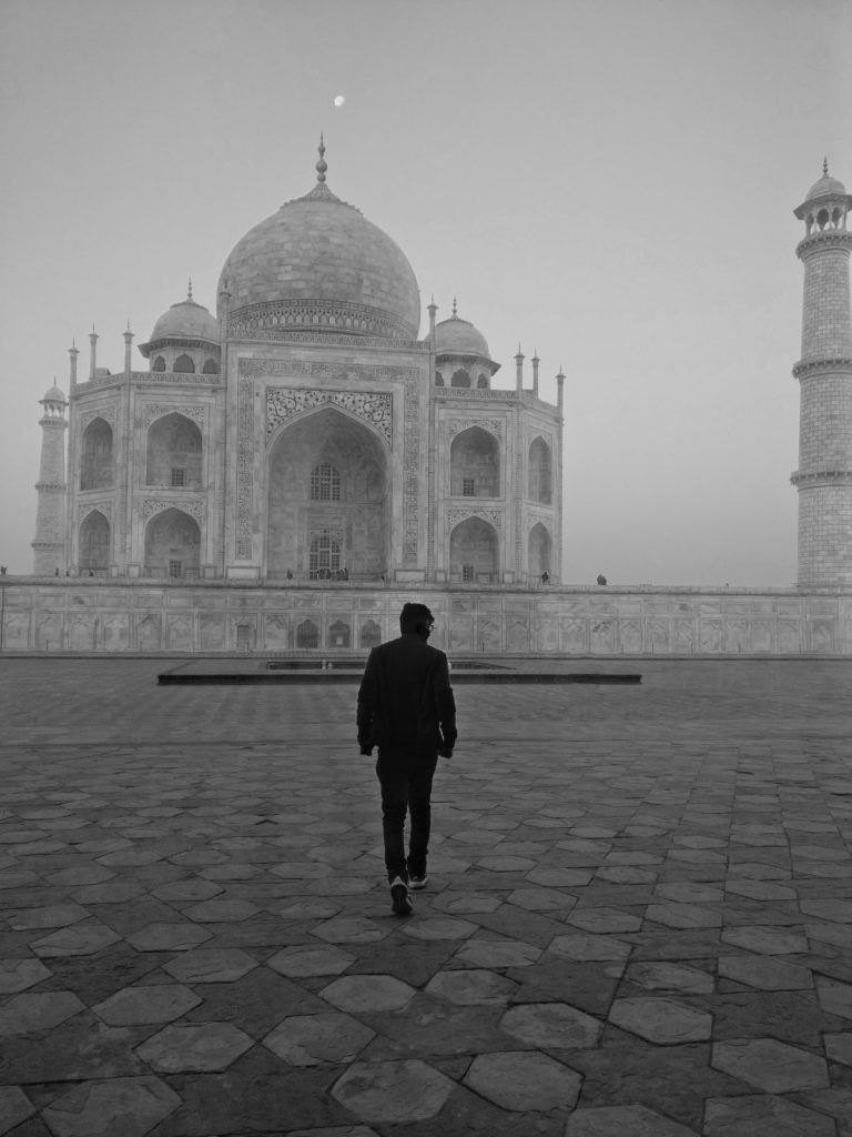 man walking towards a temple