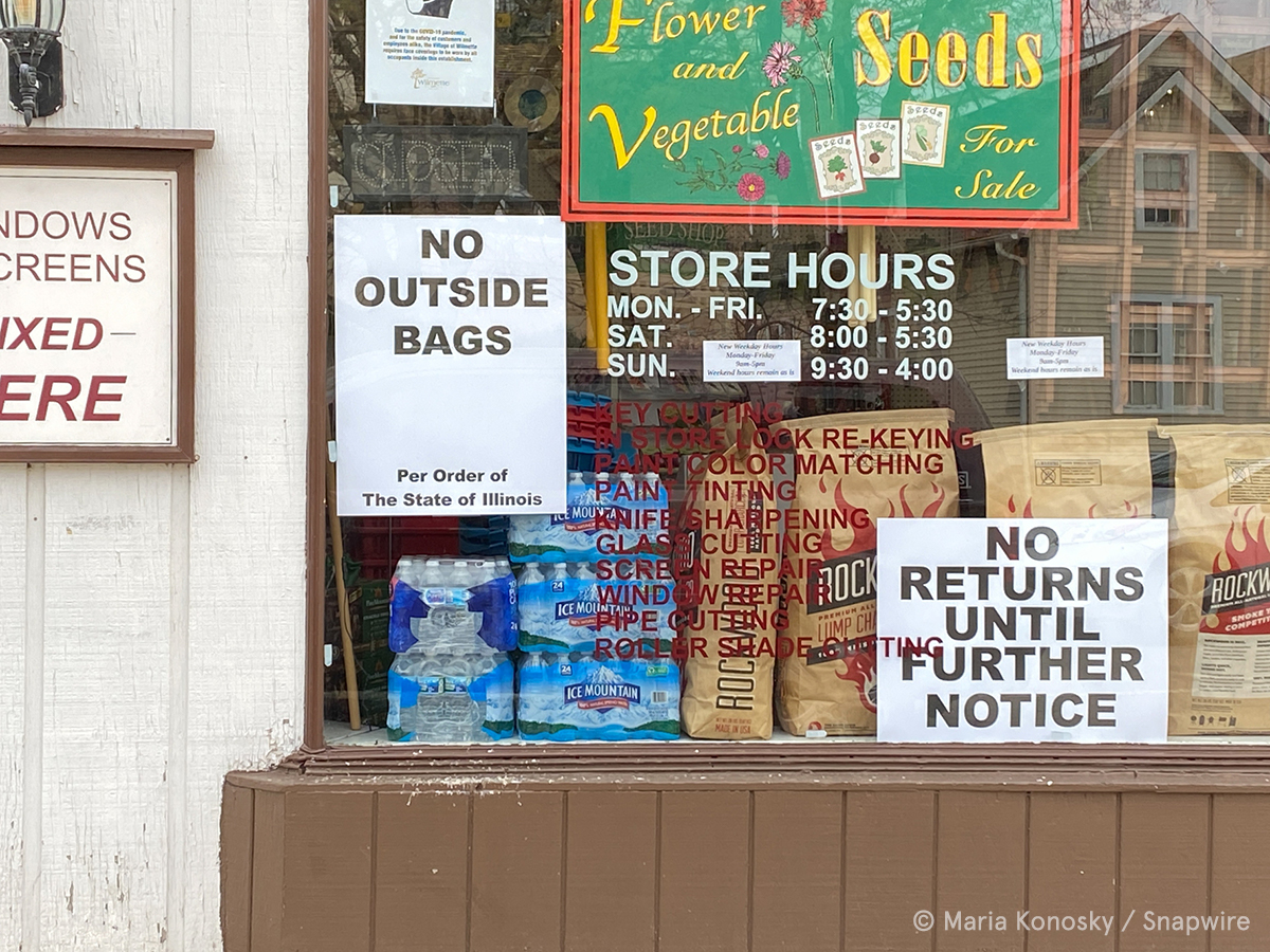 store window with covid signs