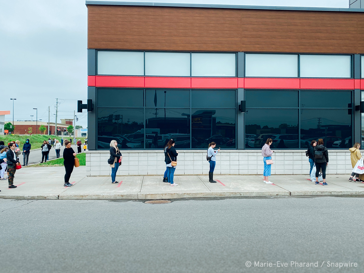 people standing in line to go into store