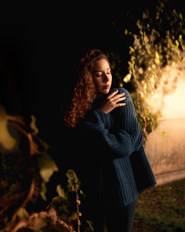 Girl giving herself a hug in the outdoors