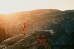 Photographer taking photo on rock cliff