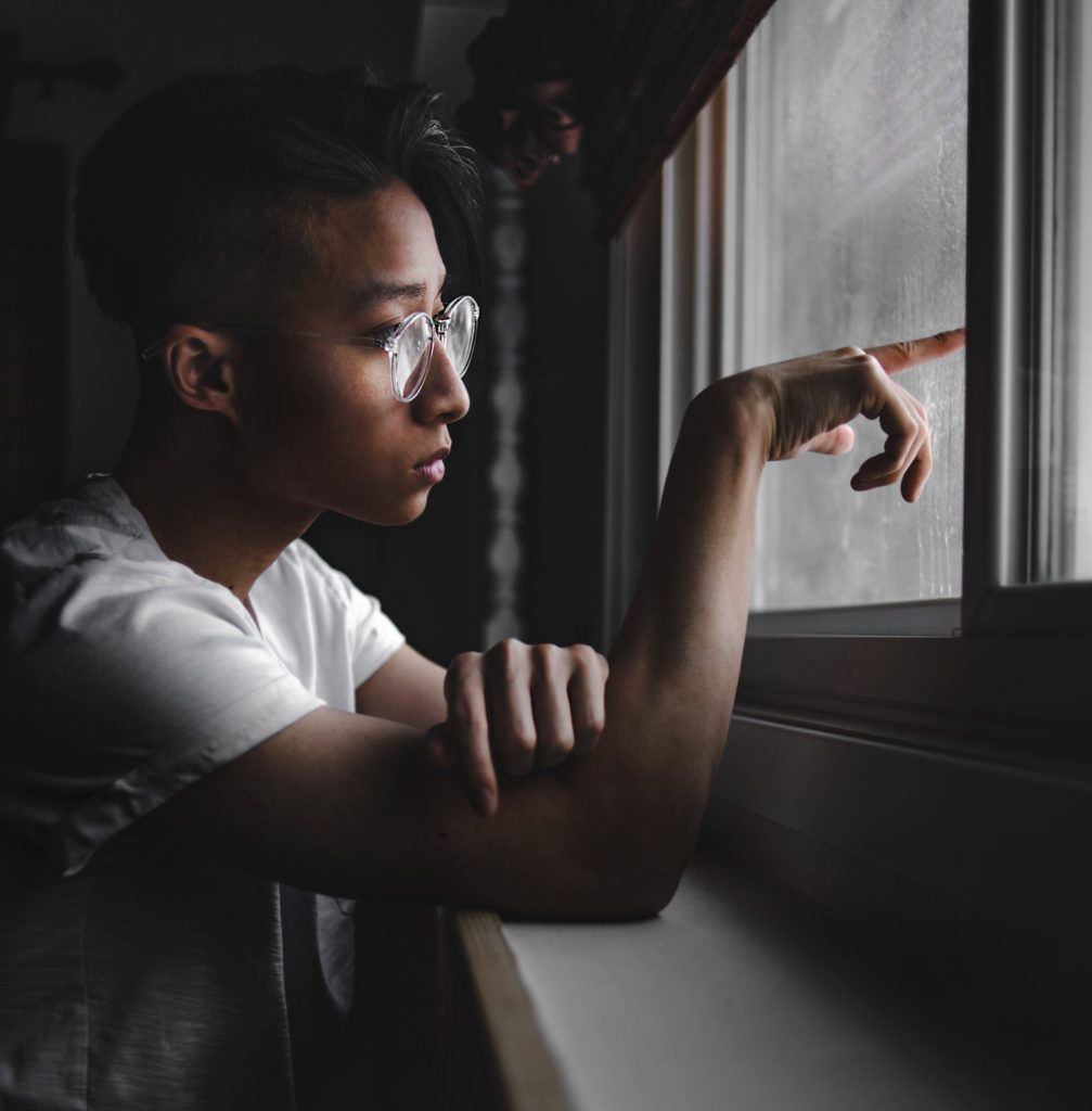 profile of a man pointing out the window