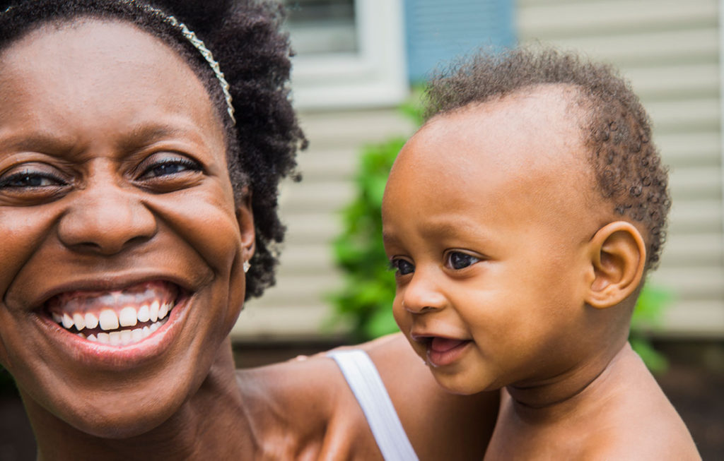 portrait girl smiling with a baby