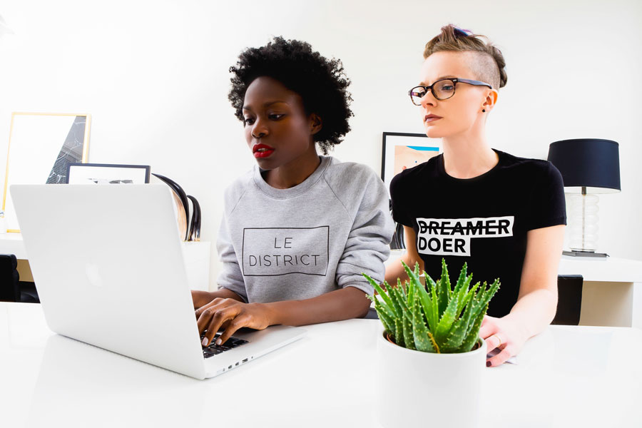 Two women in the office looking at a computer