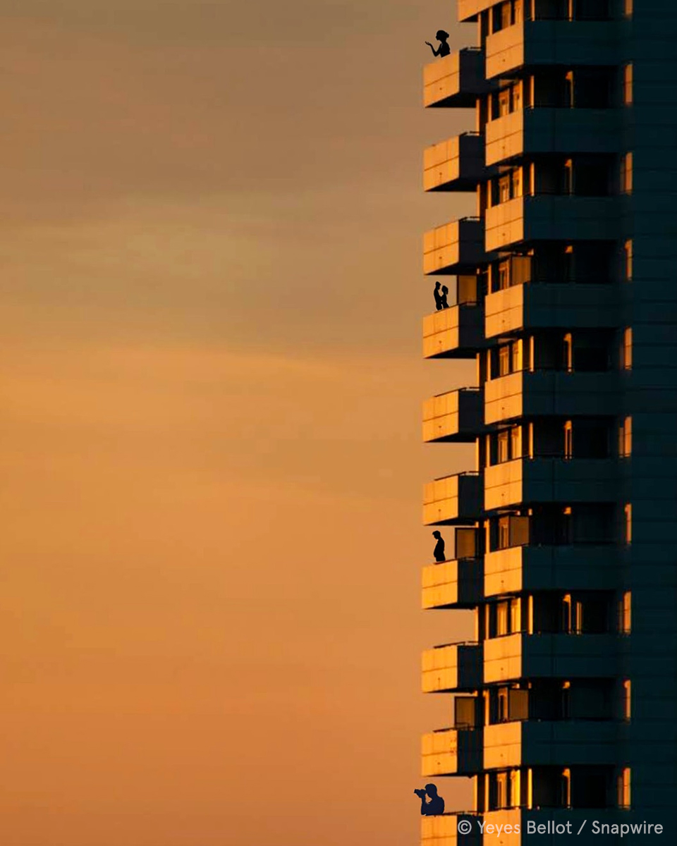 building with people standing on the balcony